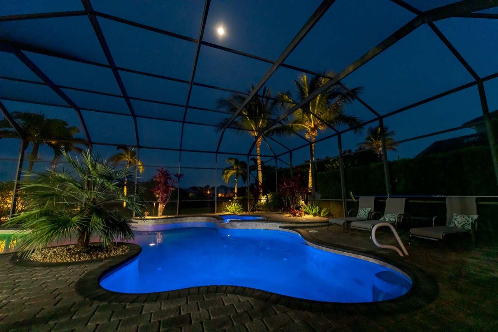 Screened Pool & Spa at Dusk, Landscape Lighting project in Satellite Beach, FL